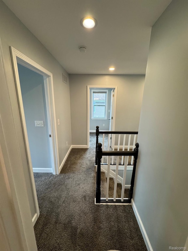 677 King Cir, Lake Orion, MI 48362 - corridor with dark carpet, recessed lighting, and an upstairs landing