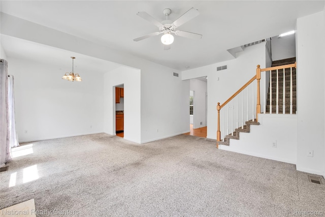 1236 University Dr, Pontiac, MI 48342 - unfurnished living room featuring stairs, a chandelier, a ceiling fan, and carpet flooring