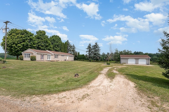 5010 N Pendell Rd, Alma, MI 48801 - view of front of home with an outdoor structure, driveway, a front yard, and a garage