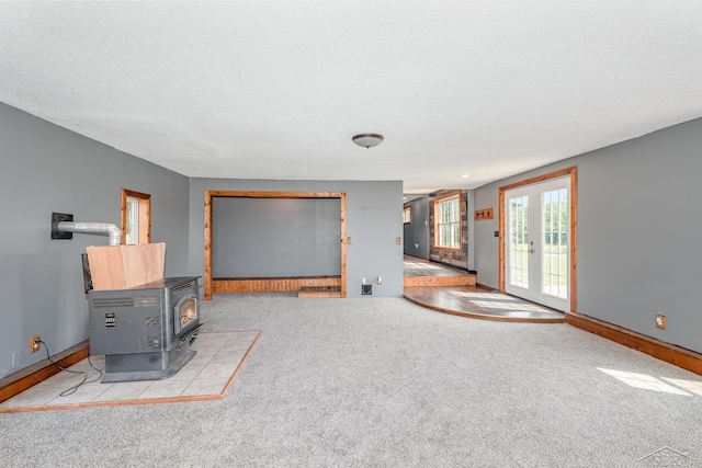 5010 N Pendell Rd, Alma, MI 48801 - unfurnished living room with a wood stove and carpet