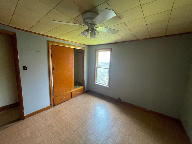 262 5th St, Manistee, MI 49660 - unfurnished bedroom featuring baseboards and a ceiling fan