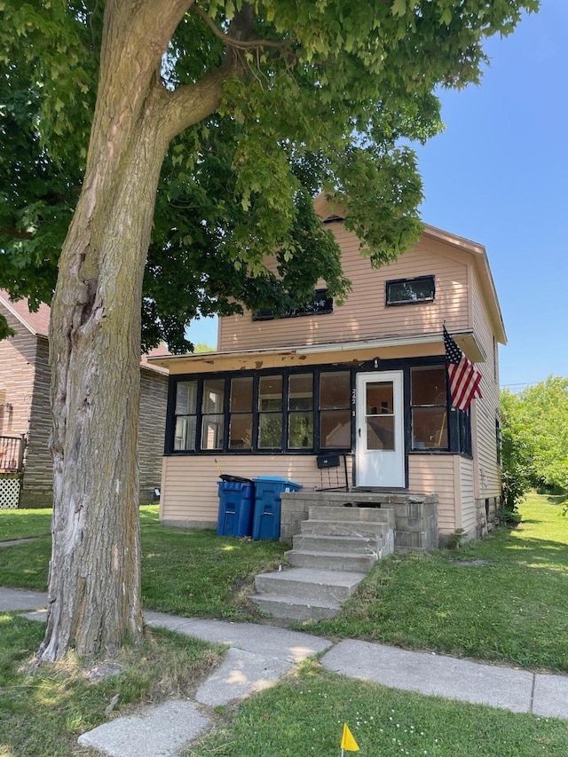 262 5th St, Manistee, MI 49660 - view of front of house with a front yard