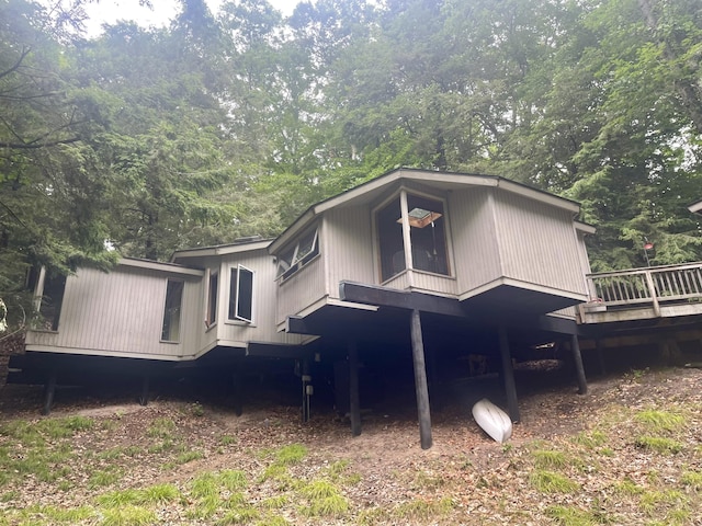 10304 Lost Valley Rd Unit 12, Montague, MI 49437 - rear view of house featuring a wooden deck and a forest view
