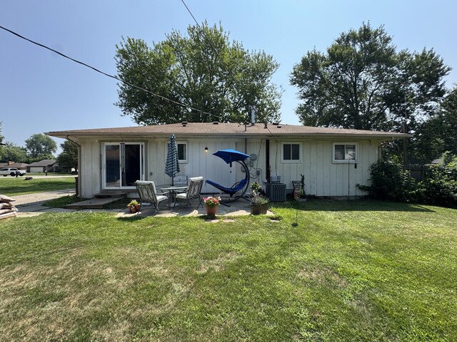 39909 Bridgeview St, Harrison Township, MI 48045 - rear view of property with a patio, a yard, and board and batten siding