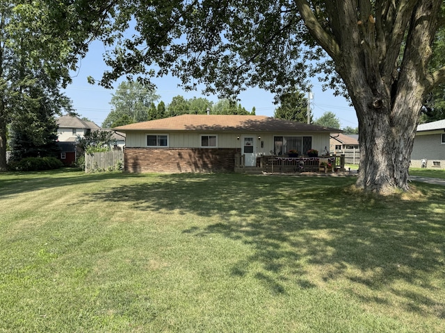 39909 Bridgeview St, Harrison Township, MI 48045 - rear view of house featuring a yard and brick siding