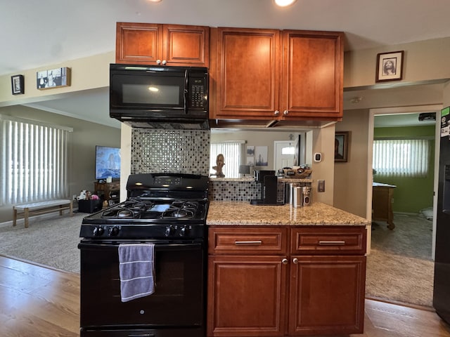 39909 Bridgeview St, Harrison Township, MI 48045 - kitchen featuring black appliances, wood finished floors, backsplash, light stone counters, and carpet flooring