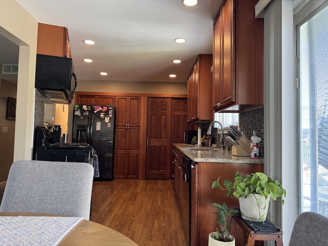 39909 Bridgeview St, Harrison Township, MI 48045 - kitchen with wood finished floors, backsplash, black appliances, recessed lighting, and brown cabinetry