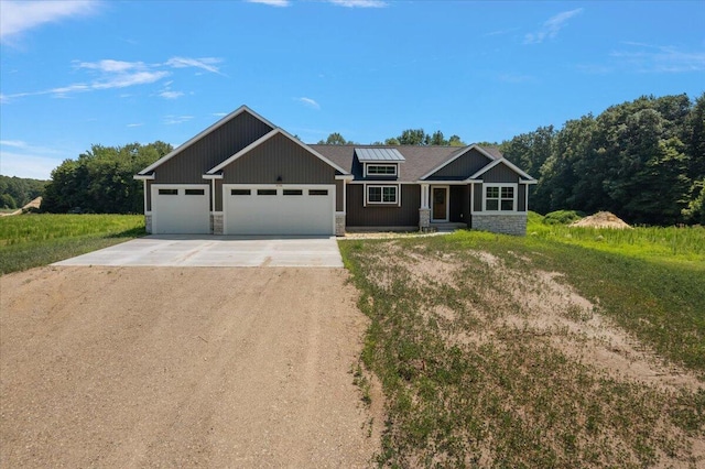 6766 Baldwin St, Hudsonville, MI 49426 - craftsman-style home featuring driveway, stone siding, and a garage