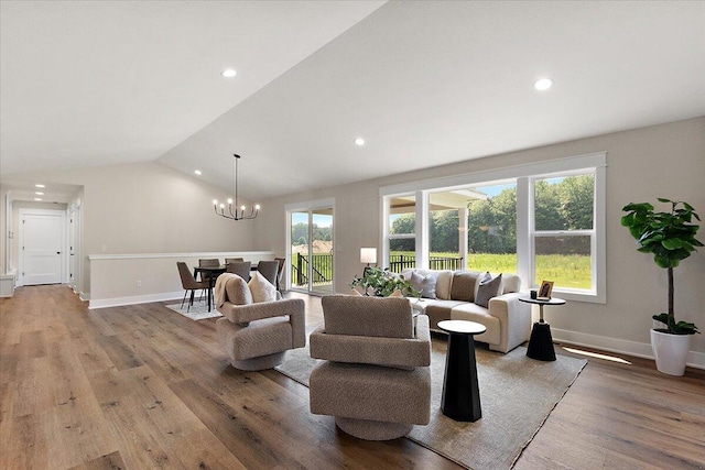 6766 Baldwin St, Hudsonville, MI 49426 - living area with wood finished floors, a chandelier, recessed lighting, and vaulted ceiling