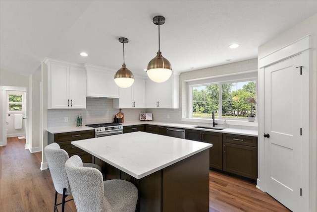 6766 Baldwin St, Hudsonville, MI 49426 - kitchen with a kitchen island, tasteful backsplash, wood finished floors, and recessed lighting