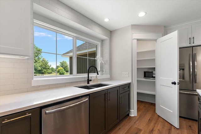 6766 Baldwin St, Hudsonville, MI 49426 - kitchen with stainless steel appliances, backsplash, wood finished floors, white cabinets, and recessed lighting