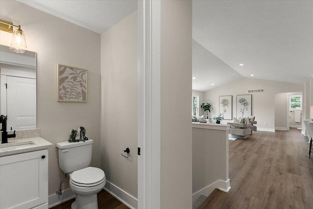 6766 Baldwin St, Hudsonville, MI 49426 - bathroom with wood finished floors, vanity, healthy amount of natural light, lofted ceiling, and recessed lighting