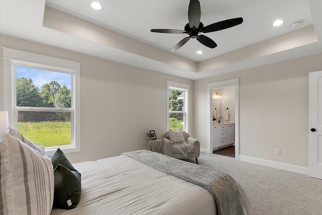 6766 Baldwin St, Hudsonville, MI 49426 - bedroom with carpet, a tray ceiling, recessed lighting, ensuite bathroom, and a ceiling fan
