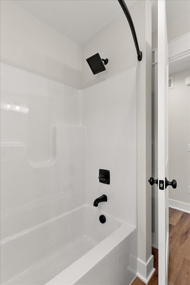 6766 Baldwin St, Hudsonville, MI 49426 - bathroom featuring wood finished floors and bathtub / shower combination