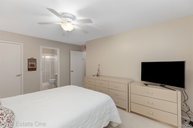 1127 S Lake Dr Unit 212, Novi, MI 48377 - bedroom featuring connected bathroom, ceiling fan, and light carpet