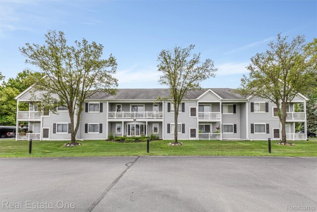 1127 S Lake Dr Unit 212, Novi, MI 48377 - view of front of home featuring a front lawn and a balcony
