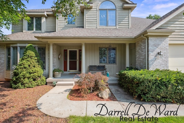 2711 Byron Station Dr SW, Byron Center, MI 49315 - view of front of property featuring a porch, board and batten siding, brick siding, roof with shingles, and an attached garage