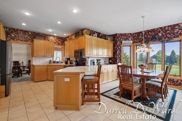 2711 Byron Station Dr SW, Byron Center, MI 49315 - kitchen featuring wallpapered walls, appliances with stainless steel finishes, a peninsula, light countertops, and light tile patterned flooring