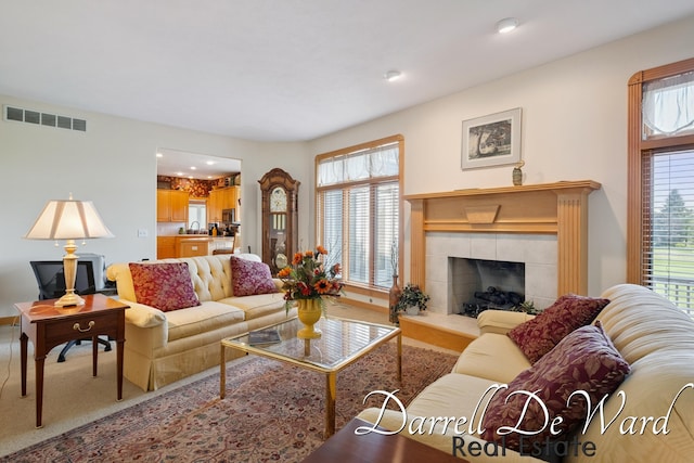 2711 Byron Station Dr SW, Byron Center, MI 49315 - living room featuring plenty of natural light, a tiled fireplace, carpet floors, and recessed lighting