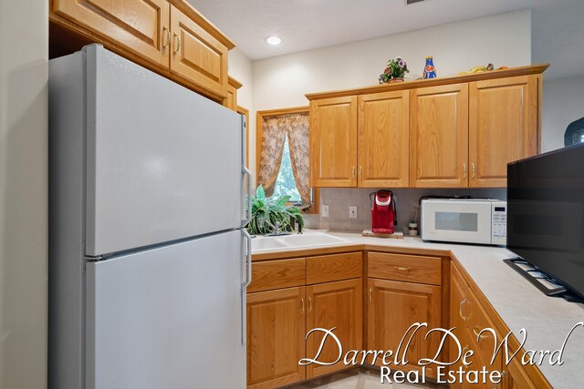2711 Byron Station Dr SW, Byron Center, MI 49315 - kitchen with white appliances, light countertops, and tasteful backsplash