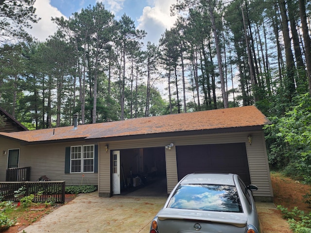 3930 Brenlor Ave, Hesperia, MI 49421 - garage featuring view of wooded area and driveway