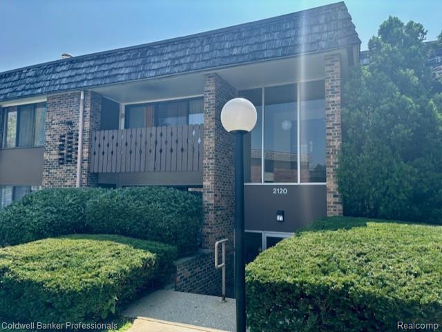 2120 Pauline Blvd Unit 305, Ann Arbor, MI 48103 - exterior view of brick siding, mansard roof, and a downspout