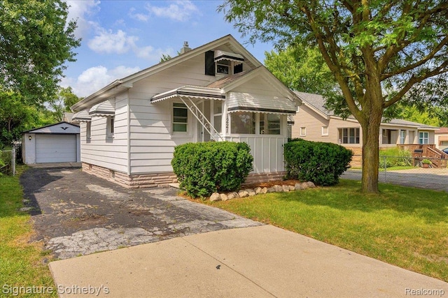 1221 E 13 Mile Rd, Royal Oak, MI 48073 - view of front of house featuring driveway, an outdoor structure, a detached garage, and a front lawn