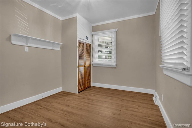 1221 E 13 Mile Rd, Royal Oak, MI 48073 - unfurnished bedroom featuring a closet, wood finished floors, and crown molding
