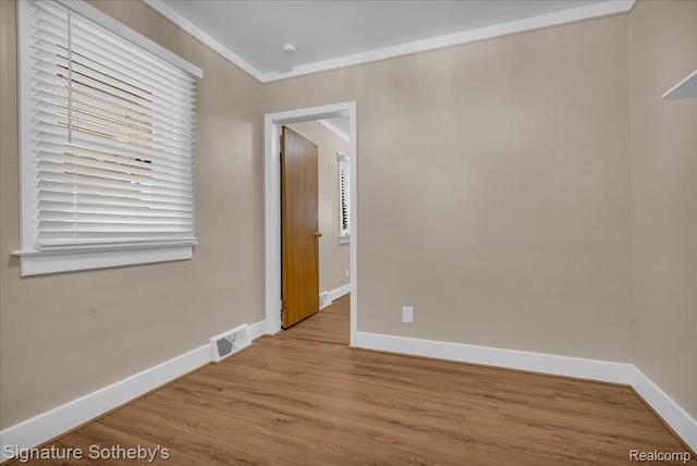 1221 E 13 Mile Rd, Royal Oak, MI 48073 - empty room with wood finished floors and ornamental molding