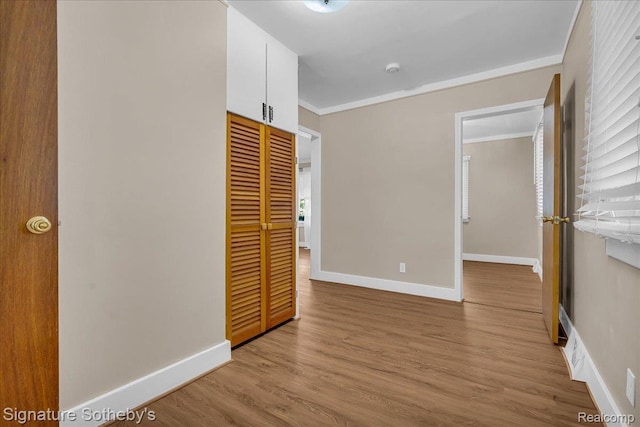 1221 E 13 Mile Rd, Royal Oak, MI 48073 - unfurnished bedroom featuring crown molding, a closet, and wood finished floors