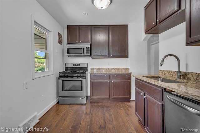 1221 E 13 Mile Rd, Royal Oak, MI 48073 - kitchen featuring stainless steel appliances, dark wood finished floors, light stone counters, and dark brown cabinetry