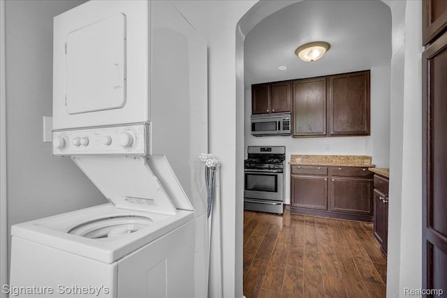 1221 E 13 Mile Rd, Royal Oak, MI 48073 - laundry area with stacked washer / drying machine and dark wood-type flooring