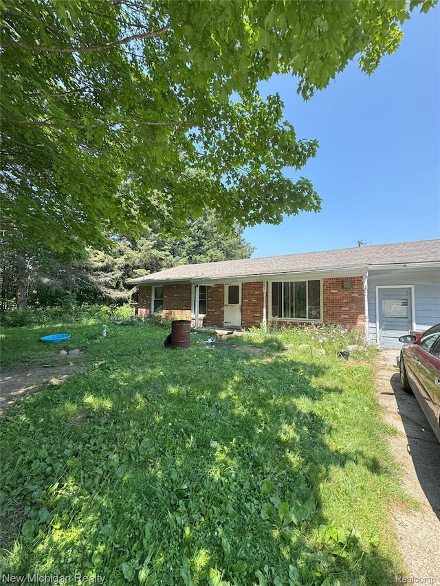 5407 Ostrom Rd, Attica, MI 48412 - single story home with brick siding and a front lawn