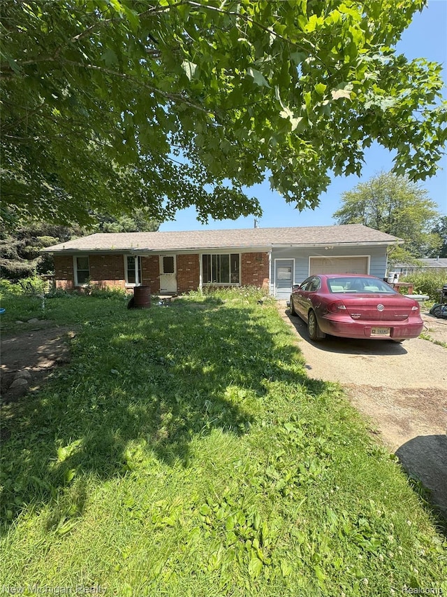 5407 Ostrom Rd, Attica, MI 48412 - ranch-style house featuring an attached garage, driveway, a front lawn, and brick siding
