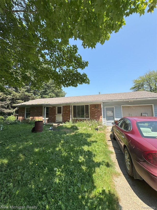 5407 Ostrom Rd, Attica, MI 48412 - single story home featuring brick siding, a front lawn, a garage, and a shingled roof