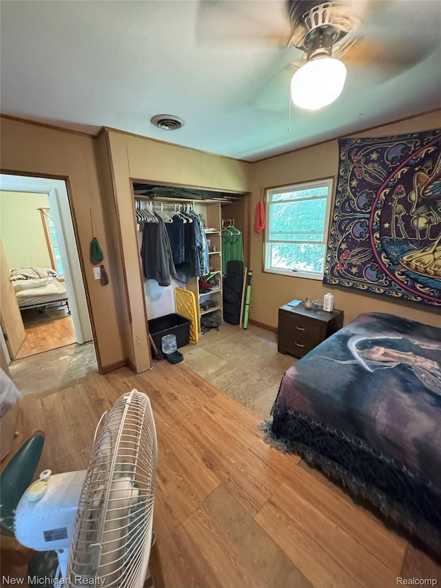 5407 Ostrom Rd, Attica, MI 48412 - bedroom featuring wood finished floors, a closet, and a ceiling fan