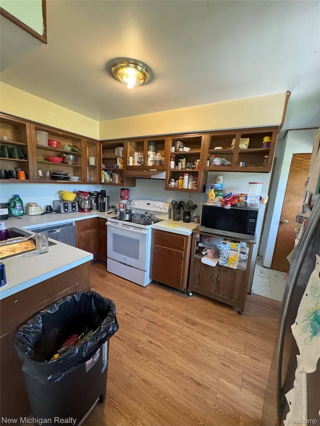 5407 Ostrom Rd, Attica, MI 48412 - kitchen featuring open shelves, white electric stove, stainless steel microwave, light wood-type flooring, and light countertops
