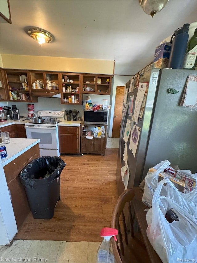 5407 Ostrom Rd, Attica, MI 48412 - kitchen featuring open shelves, white electric stove, freestanding refrigerator, and light countertops