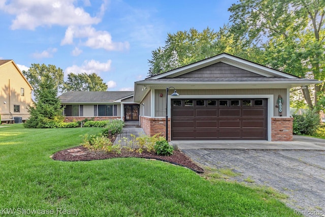 1830 Majon, Highland, MI 48356 - view of front of property with brick siding, driveway, a front lawn, and an attached garage