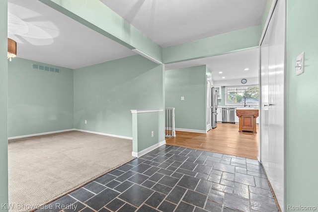 1830 Majon, Highland, MI 48356 - carpeted spare room with stone tile flooring and baseboards
