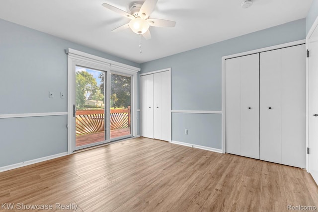 1830 Majon, Highland, MI 48356 - unfurnished bedroom featuring access to exterior, multiple closets, wood finished floors, and ceiling fan