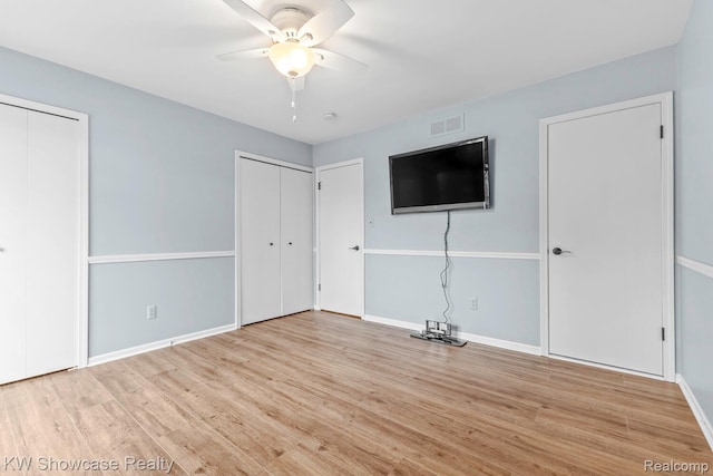 1830 Majon, Highland, MI 48356 - unfurnished bedroom with two closets, wood finished floors, and ceiling fan