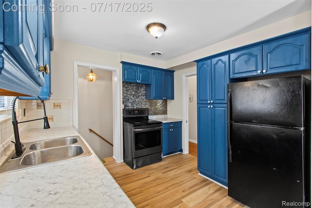 7235 Stout St, Detroit, MI 48228 - kitchen featuring freestanding refrigerator, blue cabinets, electric range oven, backsplash, and light wood-style floors