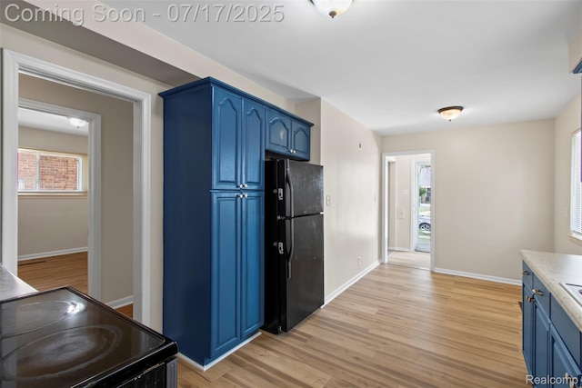 7235 Stout St, Detroit, MI 48228 - kitchen featuring blue cabinetry, black appliances, light wood finished floors, and light countertops
