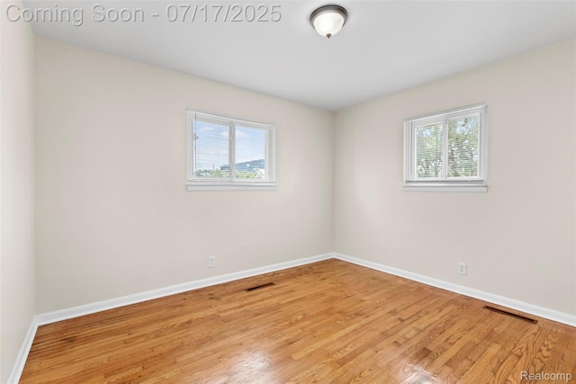 7235 Stout St, Detroit, MI 48228 - empty room with plenty of natural light and wood finished floors