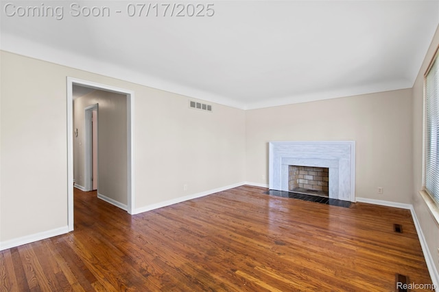 7235 Stout St, Detroit, MI 48228 - unfurnished living room with wood finished floors and a fireplace with flush hearth