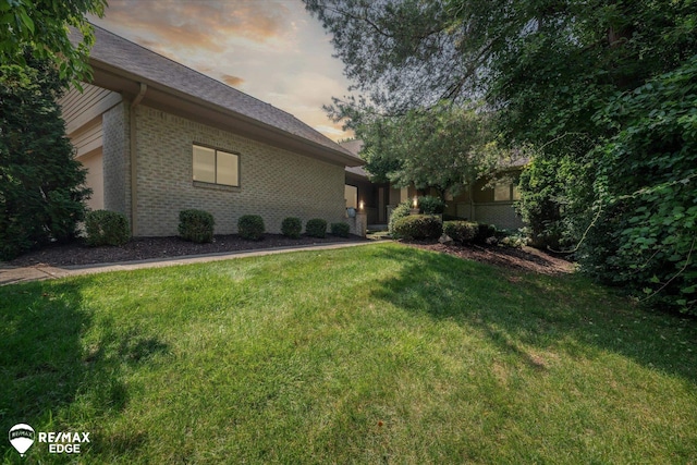 8078 Hawkcrest Dr, Grand Blanc, MI 48439 - yard at dusk featuring a lawn