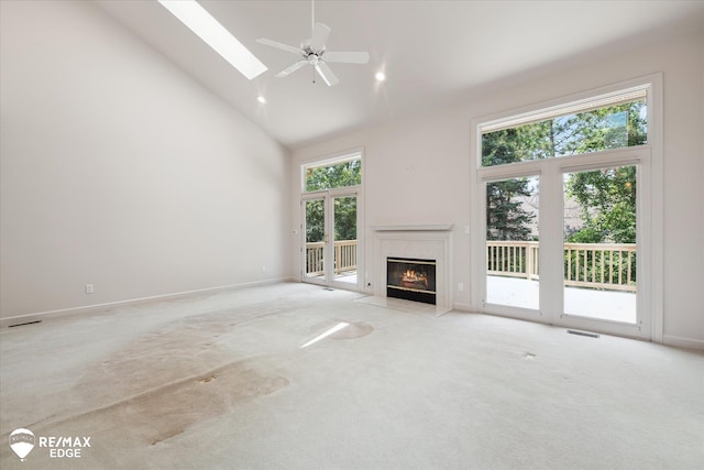 8078 Hawkcrest Dr, Grand Blanc, MI 48439 - unfurnished living room featuring high vaulted ceiling, light carpet, a premium fireplace, a skylight, and a ceiling fan