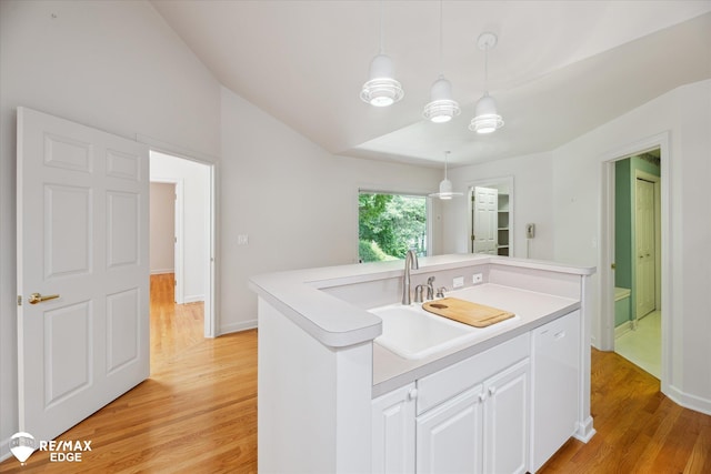 8078 Hawkcrest Dr, Grand Blanc, MI 48439 - kitchen featuring light wood-style floors, white cabinetry, hanging light fixtures, a center island with sink, and light countertops