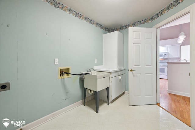 8078 Hawkcrest Dr, Grand Blanc, MI 48439 - washroom with hookup for an electric dryer, washer hookup, light flooring, and cabinet space